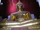 Bangkok 05 02 Ayutthaya Viharn Phra Mongkol Bophit Buddha Statue Ayutthaya�s Viharn Phra Mongkol Bophit houses an immense 17m high sitting Buddha, made from brick and plaster and covered with bronze 3-4 inches stick. The Buddha is 12.45 metres high and his lap is 9.55 metres wide. Damaged and then repaired when the original viharn collapsed in the 18th century, this giant Buddha stood in the open for the next 200 years. One of the largest in Thailand, it was sculpted, according to the site guidebook, in 1538 at Wat Chichiang.